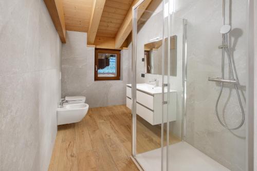 a bathroom with a shower and a sink and a toilet at Chalet Serenella in Valdidentro