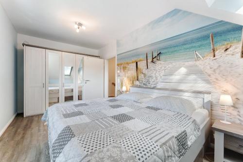 a bedroom with a large painting of the beach at Feriendoppelhaus Frühling in Stakendorf