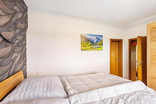 a bedroom with a bed and a painting on the wall at Perle am Pön in Medebach