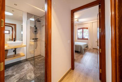 a bathroom with a glass shower and a sink at Callao in Playa Honda