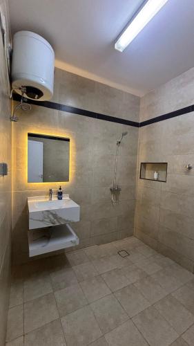 a bathroom with a sink and a mirror at Qantab village apartment in Muscat
