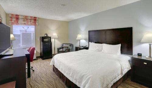 a hotel room with a bed and a desk at The Antioch Inn in Nashville