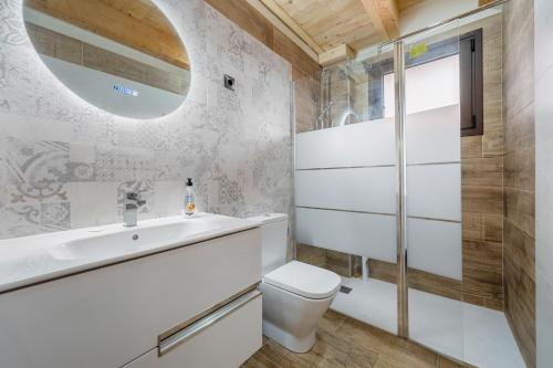 a bathroom with a sink toilet and a mirror at Sierra De Majalinos in Ejulve