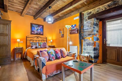 a bedroom with a bed and a couch at Loureiro in Vega de Logares