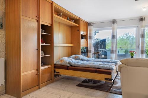 a bedroom with wooden cabinets and a bed at Apartment Seeadler in Butjadingen