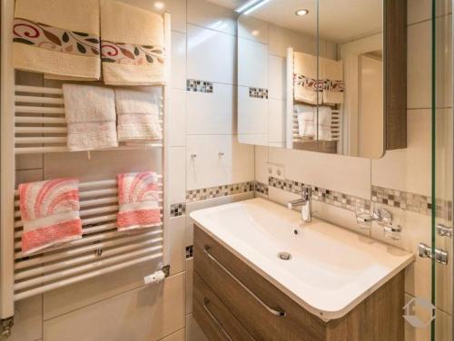 a bathroom with a sink and a mirror at Ferienwohnung Landidyll in Enzklösterle
