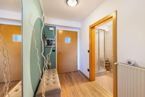 a hallway with a stairway leading to a bathroom at Appartement Annie in Nova Ponente