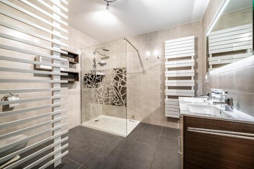 a bathroom with a shower and a sink at Les loges blanches204 centre chatel in Châtel