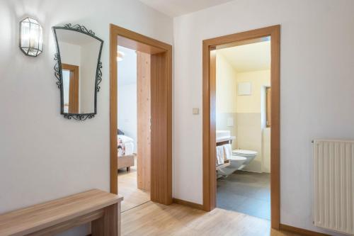 a bathroom with a mirror and a toilet in a room at Schneewittchen Schlosshof in Völs am Schlern