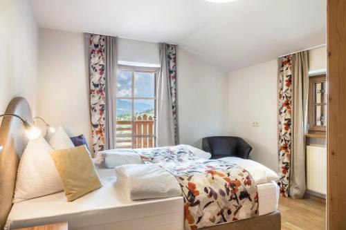 a bedroom with a bed and a window at Schneewittchen Schlosshof in Völs am Schlern