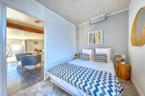 a bedroom with a bed and a living room at Sur La Route Des Vins - Libourne in Libourne