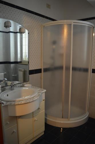 a bathroom with a shower and a white sink at La Casa di Giulia in Forza dʼAgro