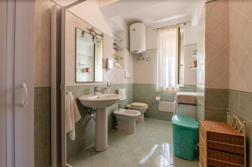 a bathroom with a sink and a toilet at Appartamento Vacanza Gliaca in Piraino