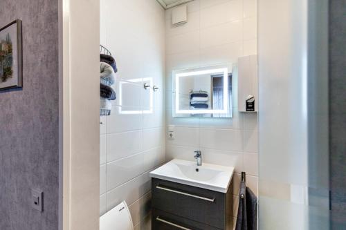 a white bathroom with a sink and a mirror at Ferienwohnung Klug in Haintchen