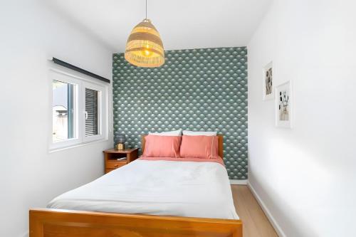 a bedroom with a bed with red pillows at Casa Da Quelha in Armamar