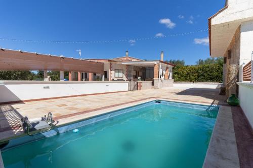 a swimming pool in the backyard of a house at Dimora Home Sweet Home with Private Pool in Putignano