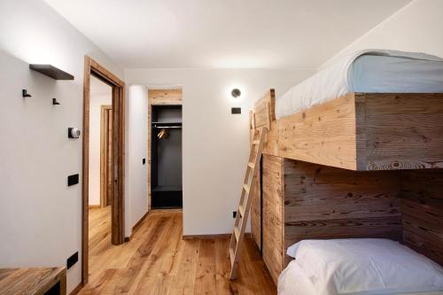 a room with two bunk beds and a hallway at Valgrisa Mountain Lodges 3 in Valgrisenche