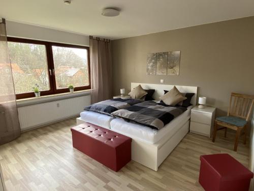 a bedroom with a large bed and a chair at Fewo Am Edersee in Edertal