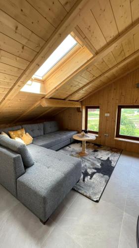 a living room with a couch and a table at Truma Swing Castelfondo in Castelfondo