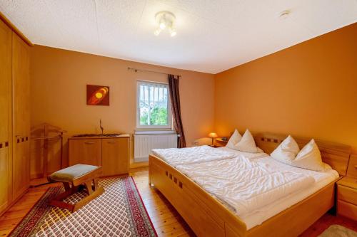 a bedroom with a large bed and a window at Haus Gertrud in Monzelfeld