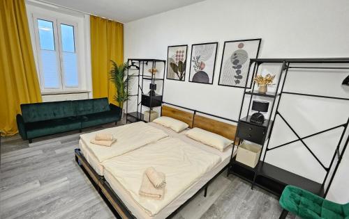 a bedroom with a bed and a couch at Relax in der Röntgenstadt in Remscheid