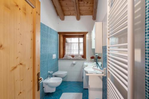 a bathroom with a toilet and a sink at Appartamenti Marmolada Falcade in Falcade