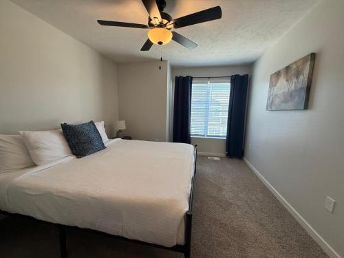 a bedroom with a bed and a ceiling fan at The Meadowlark at Coventry Rows in Omaha