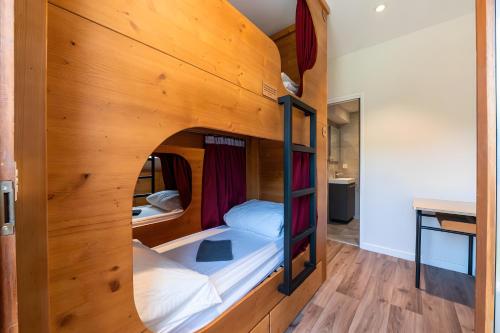 a room with two bunk beds in a house at Hostel du Val de Tamié in Faverges