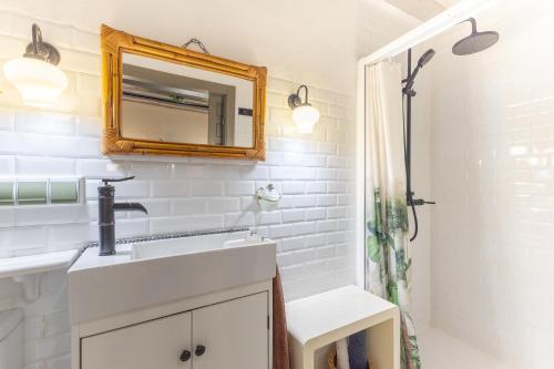 a bathroom with a sink and a mirror at La Casona Del Tio Pedro in Cadalso de los Vidrios
