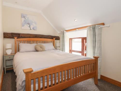 a bedroom with a large bed and a window at Mulberry Manor in Hull