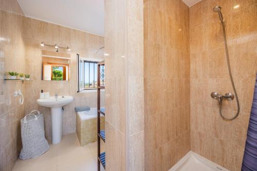 a bathroom with a shower and a sink at Finca Blanca in Calas de Mallorca