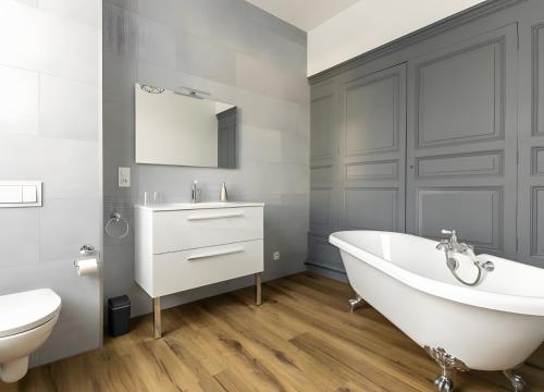 a bathroom with a tub and a toilet and a sink at Château De Saint Mayeul in Joze