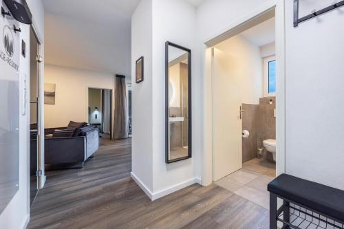 a room with a bathroom with a bed and a mirror at Egge Resort 7g mit Whirpool u Sauna in Altenbeken
