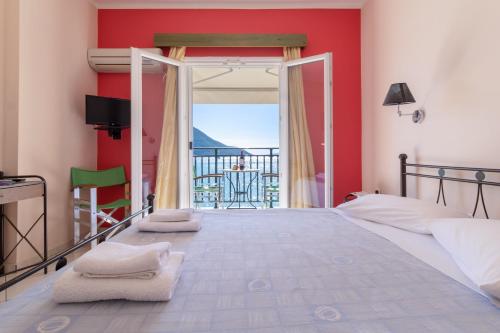 a bedroom with a bed with a view of the ocean at Apostolos Apartment 2 in Póndi