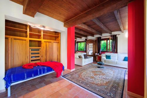 a bedroom with a bed and a living room at Il Trucchetto - Castagneto Po in Chivasso