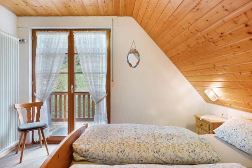 a bedroom with a bed and a wooden ceiling at Ferienwohnungen Vogt's Libding in Bad Rippoldsau-Schapbach