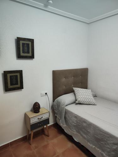 a small bedroom with a bed and a night stand at Marina Golf in Mojácar