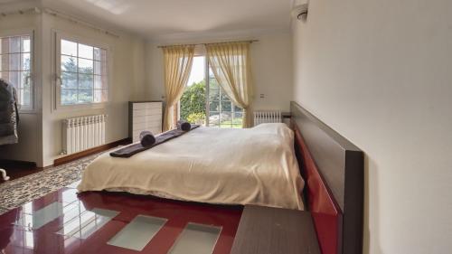 a bedroom with a large bed and a large window at Costacabana - Villa Beyonce in Lloret de Mar