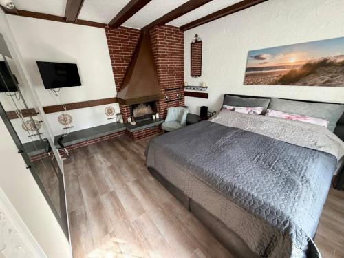 a bedroom with a large bed and a fireplace at Sterntaler Melsungen in Melsungen