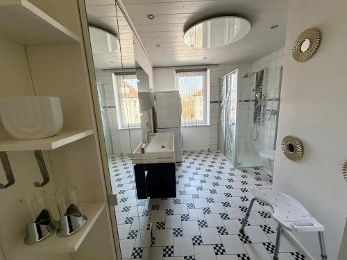 a bathroom with a sink and a shower and a toilet at Sterntaler Melsungen in Melsungen