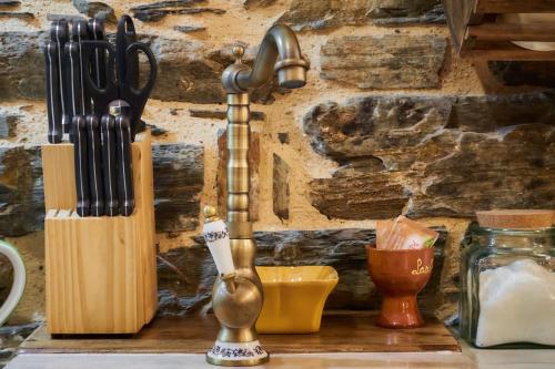 a kitchen counter with knives and utensils on a table at El Pajariel ll in Valdecañada