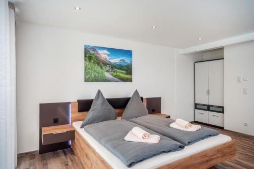 a bedroom with a large bed with two pillows at Ferienwohnung Legau in Legau