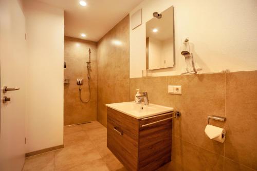 a bathroom with a sink and a shower at Ferienwohnung Legau in Legau