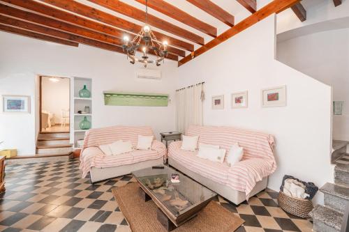 a living room with two couches and a table at La Sastreria in Pollença