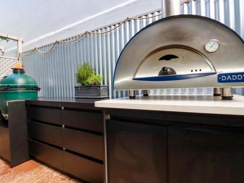 a pizza oven sitting on top of a kitchen counter at Beach View House in Newquay