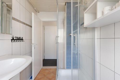 a bathroom with a glass shower and a sink at Yellow in Miltenberg