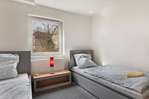 a bedroom with two beds and a window at Yellow in Miltenberg