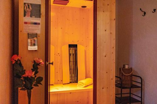 a wooden cabinet with a mirror in a room at App Hubertus - Sonnklar in Sand in Taufers