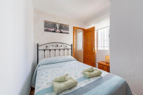 a bedroom with a bed with two pillows on it at Maracas 2 in El Pozo de los Frailes