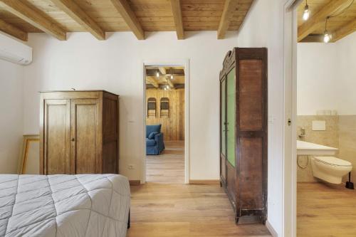 a bedroom with a bed and a bathroom with a sink at Ca' Vittorio in Rossiglione